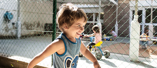 A boy plays in a nursery school playground 