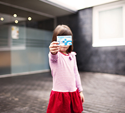 Girl showing the health card in her hand 