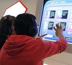 Two people touching a touchscreen to access content
