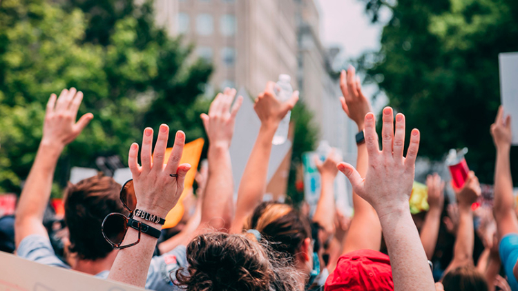 Image of people raising their hands