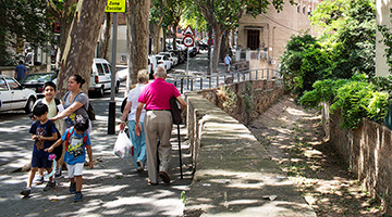 Several people walking along a street 