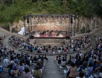 Audience attending a show at the Teatre Grec amphitheater