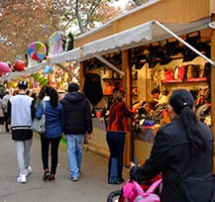 People look at toys at a stand of the Reis fair on Gran Via