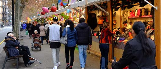 People look at toys at a stand of the Reis fair on Gran Via