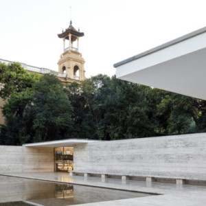 Vista exterior del Pavelló Alemany de Mies van der Rohe, amb el Pavelló 7 de la Fira de fons