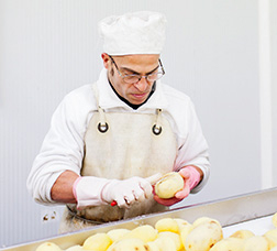 Man with functional diversity peeling potatoes