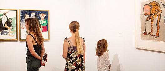Youngsters looking at works on display in a museum