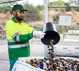 A recycling-centre worker classifies waste products.