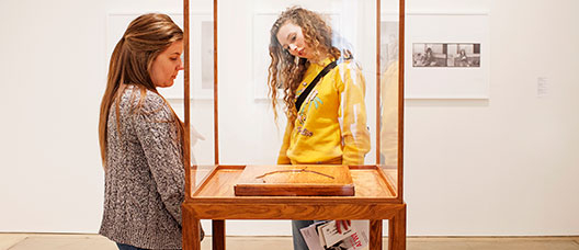 Two girls looking at an exhibition